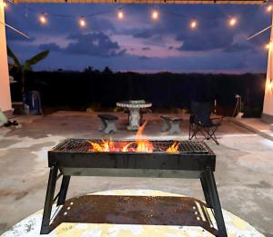 a fire pit in a patio at night at White House Villa in Sekinchan