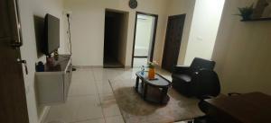 a living room with a chair and a table at Hangang M building in Avati