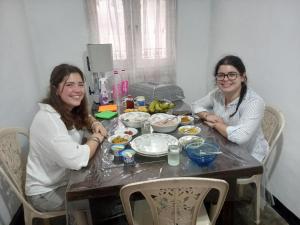 two women sitting at a table eating food at Sahan tours in Padukka