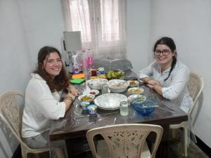 two women sitting at a table with food at Sahan tours in Padukka