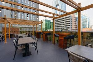 a restaurant with tables and chairs on a roof at The First Collection Marina, Dubai, a Tribute Portfolio Hotel in Dubai