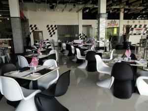 a restaurant with tables and chairs with american flags on them at Arafah Hotel Nilai in Kampong Tanjong