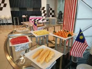 a glass table with several plates of food on it at Arafah Hotel Nilai in Kampong Tanjong