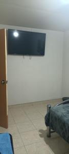 a white wall with a flat screen tv on it at Agradable habitación C in Mexicali