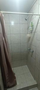 a shower with a glass door in a bathroom at Agradable habitación C in Mexicali