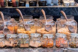 a display of jars of food on a table at Bangkok Marriott Hotel The Surawongse in Bangkok