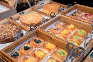 a display of different types of pastries in wooden trays at Bangkok Marriott Hotel The Surawongse in Bangkok