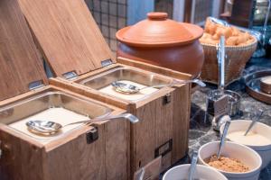 a buffet of food with spoons in a wooden box at Bangkok Marriott Hotel The Surawongse in Bangkok