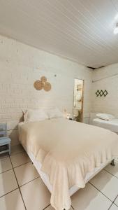a bedroom with a large white bed in a room at Chalés São Domingos in Barreirinhas