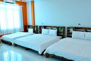 a group of three beds in a room at Mocha Vila Mộc Châu in Mộc Châu