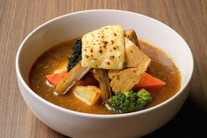 a bowl of soup with tofu and vegetables in it at ANA Crowne Plaza Sapporo by IHG in Sapporo