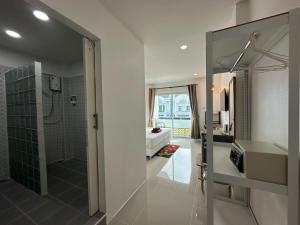 a bathroom with a shower and a sink and a mirror at Inn Dulgence in Patong Beach +85 photos