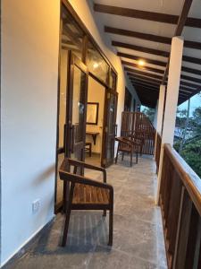 a bench on the porch of a house at Hotel Siyomin in Ahangama