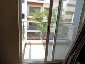 an open window with a view of a balcony at Daffodil Suites, Manyata Tech Park, Bengaluru in Bangalore