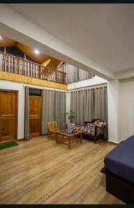 a living room with a couch and a table at Manali Parvat View in Jagatsukh