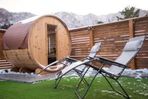 a couple of chairs sitting in front of a sauna at 禅ーZen Villa Hakodate in Hakodate