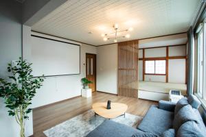 a living room with a couch and a table at 禅ーZen Villa Hakodate in Hakodate +51 photos