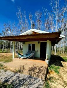 a small house with a porch and a hammock at Anna Garden Homestay in Ban Phlu Kom +7 photos