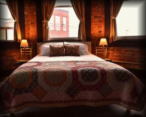 a bedroom with a large bed with a large window at Morguen Toole in Meyersdale