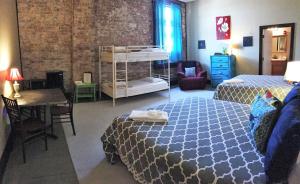 a bedroom with two beds and a table and a desk at Morguen Toole in Meyersdale