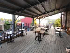 an empty patio with tables and chairs on a deck at Morguen Toole in Meyersdale