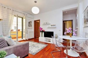 a living room with a couch and a table at Mecenate Charme Apartment in Rome