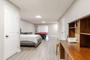 a bedroom with a bed and a pool table at Litorum - a place to land, breathe, and reset in Front Royal