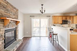 a living room with a fireplace and a kitchen at Litorum - a place to land, breathe, and reset in Front Royal