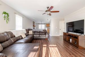 a living room with a couch and a flat screen tv at Litorum - a place to land, breathe, and reset in Front Royal