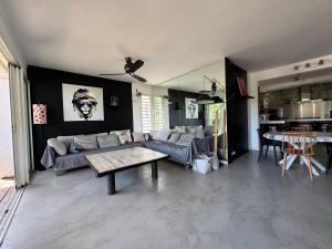a living room with a couch and a table at Maison Nature in La Possession
