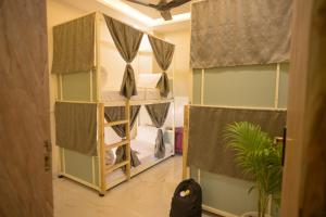 a room with a room with bunk beds in it at 3 Raahi Varanasi in Varanasi +31 photos