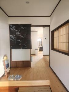 a room with two pairs of shoes on a wooden floor at 古民家宿懐 in Nachikatsuura