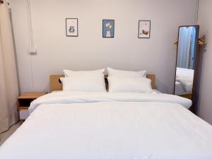a bedroom with two white beds and a mirror at Stay Together 3BR walkable to Nimman 6 Guests in Chiang Mai +10 photos