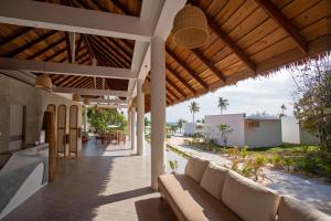 an outdoor patio of a villa with a couch at Le Baoli Koh Rong in Phumĭ Kaôh Rŏng