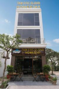 a building with tables and chairs in front of it at Tamcoc Cloud Homestay in Ninh Binh