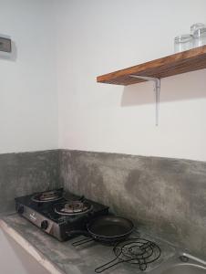 a stove top with two pans on top of it at Emerald retreat in Ahangama +8 photos