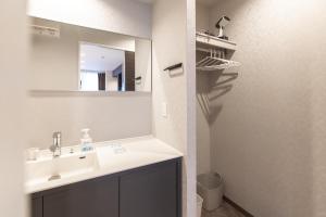 a bathroom with a sink and a mirror at ReLA Kashiwa Eki Mae in Kashiwa +32 photos