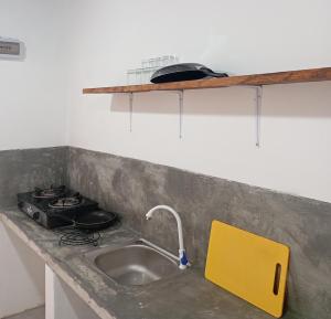 a kitchen counter with a sink and a stove at Emerald retreat in Ahangama