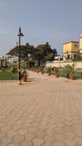 a brick sidewalk with a light pole and potted plants at Baibhab Convention & Resort in Bhubaneshwar +9 photos