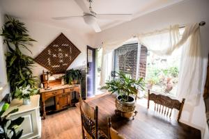 a dining room with a table and a desk with plants at Jaspers Apartments in Brunswick Heads