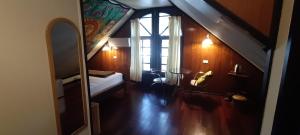 a attic room with a bed and a window at Marissa Hotel in Haad Rin