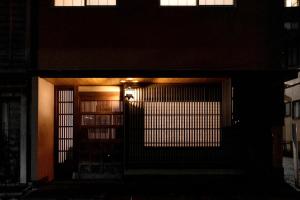an entrance to a building with a door at night at Boutique Stay Kanazawa Oost Knoll in Kanazawa +28 photos