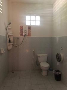 a bathroom with a toilet and a shower at Marissa Hotel in Haad Rin +50 photos