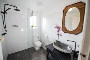 a bathroom with a sink and a toilet and a mirror at Jaspers Apartments in Brunswick Heads +94 photos