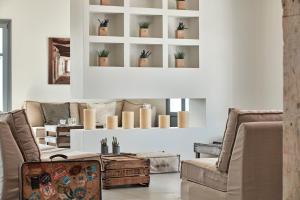 a living room with a couch and chairs at Poseidon of Paros Hotel & Spa in Chrissi Akti