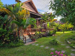 a house with a garden in front of it at The Hidden Oasis Bungalows in Kampot