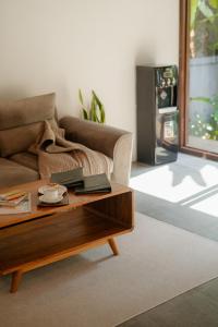 a living room with a couch and a coffee table at Abangan Bungalow in Ubud