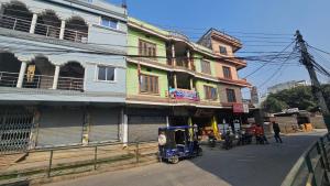 a small vehicle parked in front of a building at Hotel Rani mahal Biratnagar in Biratnagar