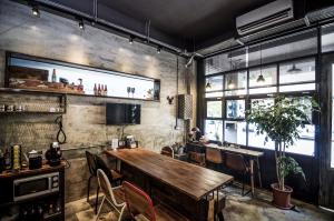 a dining room with a wooden table and chairs at You Worth Inn in Hualien City