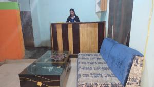 a man standing behind a podium with a glass table at Hotel Rani mahal Biratnagar in Biratnagar +2 photos